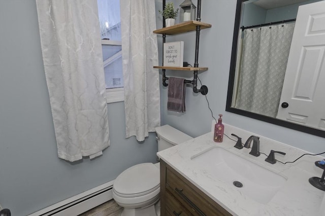 bathroom with a baseboard radiator, vanity, and toilet