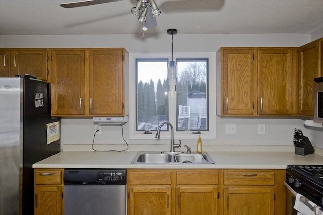 kitchen featuring appliances with stainless steel finishes, sink, ceiling fan, and decorative light fixtures