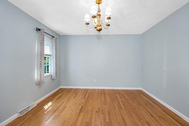 218 Acropolis Rd, Lowell, MA 01854 - empty room with a chandelier, light wood-style flooring, and baseboards