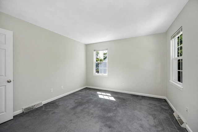 218 Acropolis Rd, Lowell, MA 01854 - unfurnished room featuring healthy amount of natural light, dark colored carpet, and baseboards