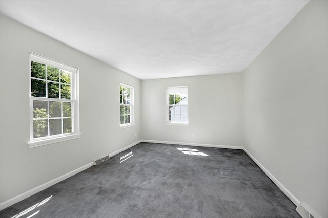 218 Acropolis Rd, Lowell, MA 01854 - empty room featuring dark colored carpet and baseboards
