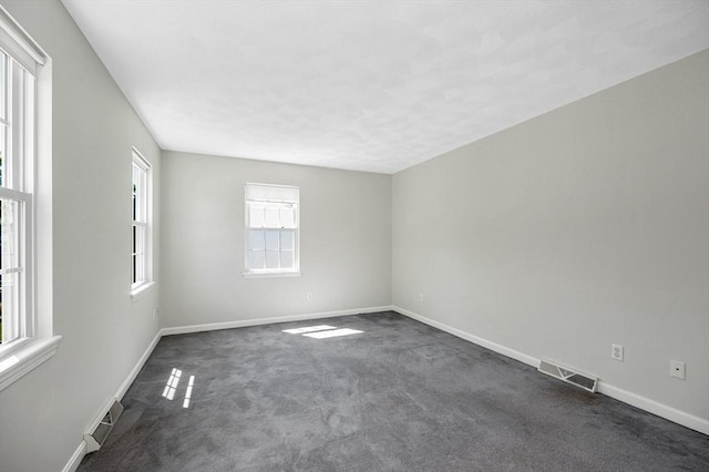 218 Acropolis Rd, Lowell, MA 01854 - spare room with dark carpet and baseboards