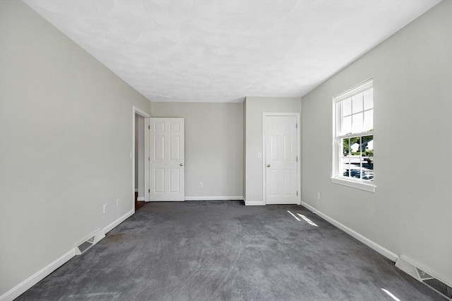 218 Acropolis Rd, Lowell, MA 01854 - empty room with baseboards and dark colored carpet