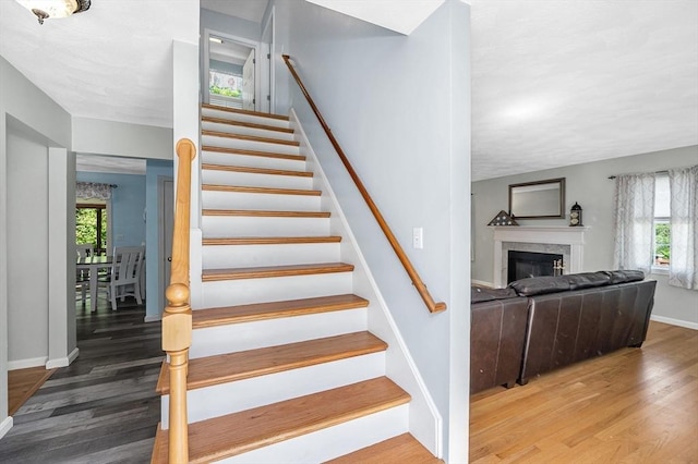 218 Acropolis Rd, Lowell, MA 01854 - staircase with wood finished floors, plenty of natural light, baseboards, and a fireplace