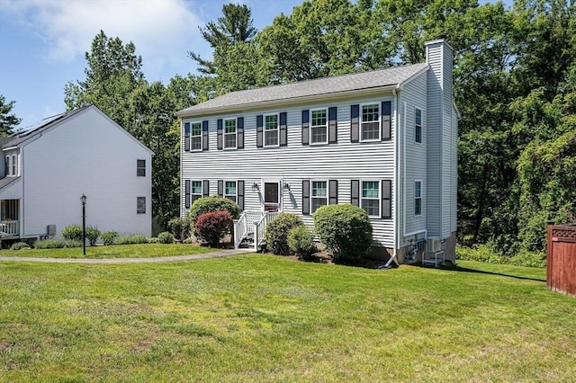 218 Acropolis Rd, Lowell, MA 01854 - colonial house with a chimney and a front lawn