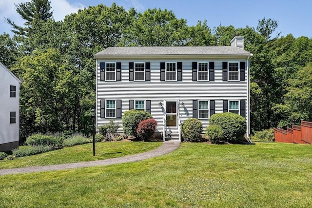 218 Acropolis Rd, Lowell, MA 01854 - colonial inspired home featuring a chimney and a front lawn