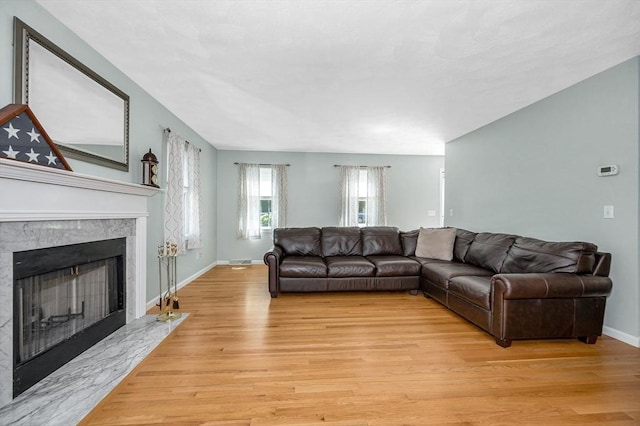 218 Acropolis Rd, Lowell, MA 01854 - living room featuring light wood finished floors, a fireplace, and baseboards