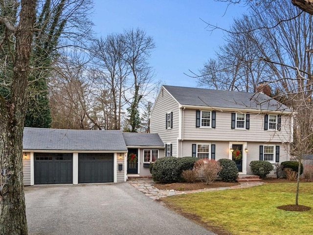 view of front facade with a garage and a front lawn