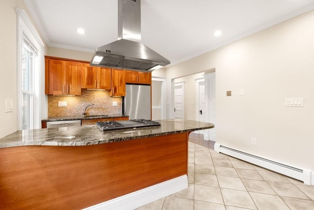 21 Searle Ave Unit 2, Brookline, MA 02445 - kitchen featuring island range hood, appliances with stainless steel finishes, a baseboard heating unit, brown cabinets, and backsplash