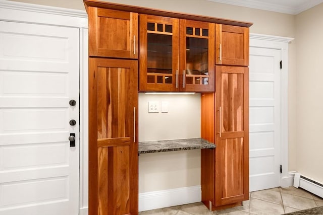 21 Searle Ave Unit 2, Brookline, MA 02445 - mudroom with baseboard heating, built in study area, ornamental molding, baseboards, and light tile patterned floors