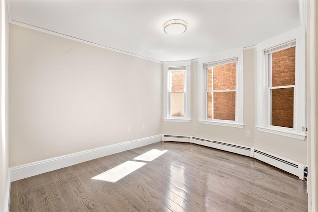 21 Searle Ave Unit 2, Brookline, MA 02445 - unfurnished room with a baseboard radiator, wood finished floors, and baseboards