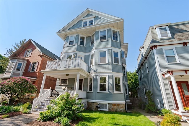 21 Searle Ave Unit 2, Brookline, MA 02445 - view of front of property featuring covered porch, a balcony, and a front lawn