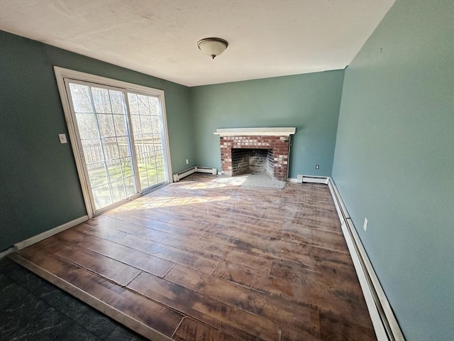 unfurnished living room with wood finished floors, baseboards, and baseboard heating