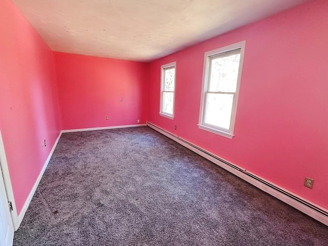 carpeted empty room featuring baseboards and baseboard heating