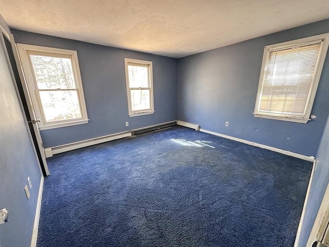 unfurnished room with a textured ceiling, baseboards, baseboard heating, and carpet