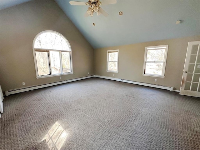 carpeted empty room with baseboard heating, a ceiling fan, and vaulted ceiling