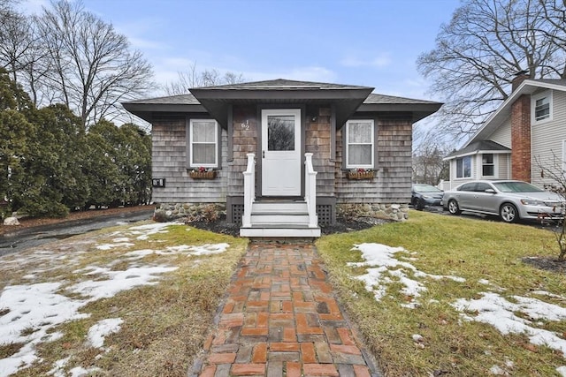 bungalow-style house with a front yard