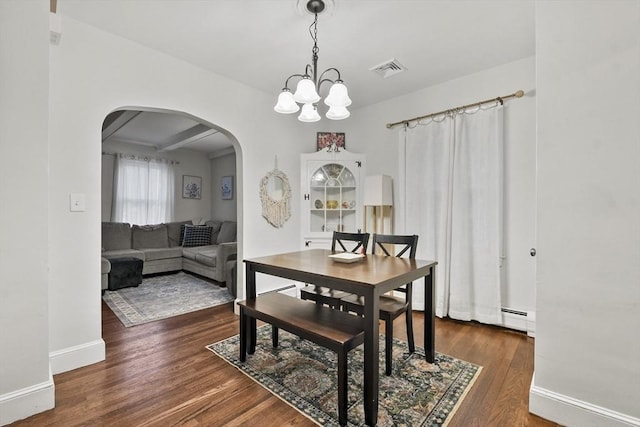 dining room featuring baseboard heating, dark hardwood / wood-style flooring, an inviting chandelier, and beam ceiling