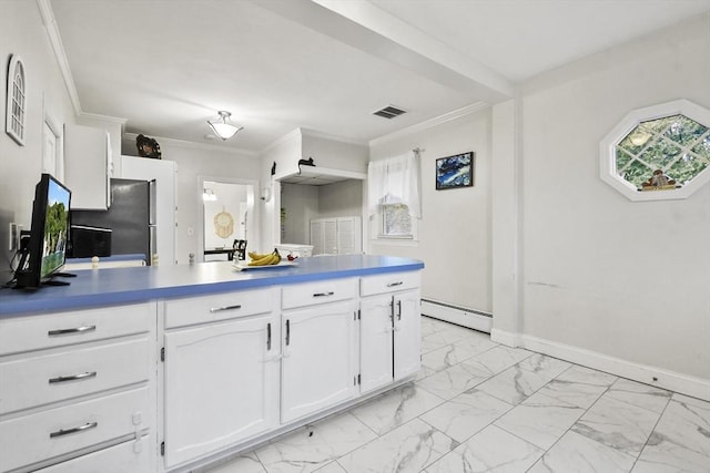 kitchen featuring white cabinetry, ornamental molding, and a baseboard heating unit