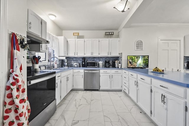 kitchen featuring white cabinetry, sink, backsplash, and appliances with stainless steel finishes