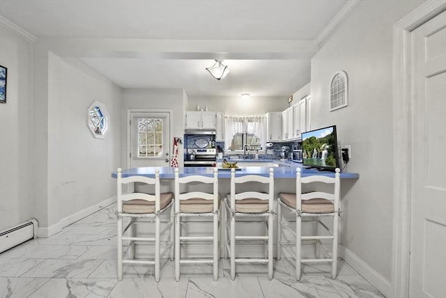 kitchen with white cabinetry, a breakfast bar area, backsplash, and kitchen peninsula