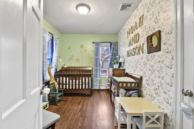 bedroom featuring dark wood-type flooring and baseboard heating