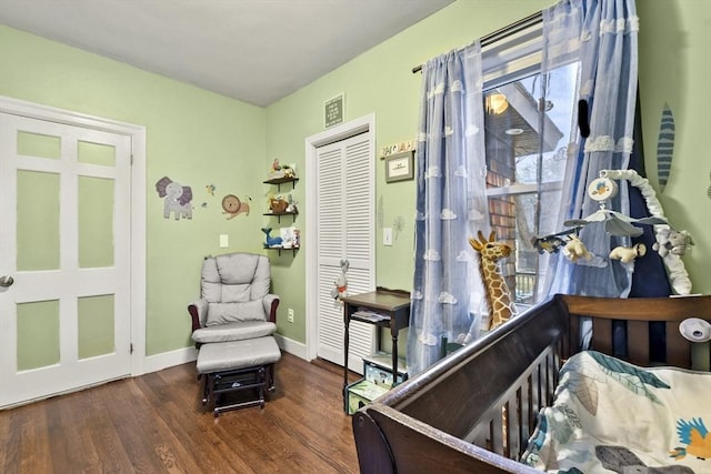 bedroom featuring dark hardwood / wood-style flooring and a closet