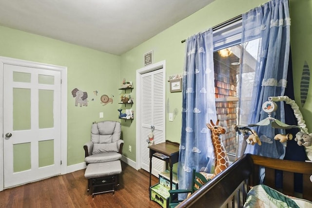 bedroom featuring dark hardwood / wood-style floors and a closet