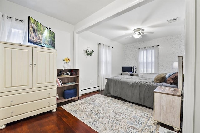 bedroom with hardwood / wood-style flooring, ceiling fan, and baseboard heating