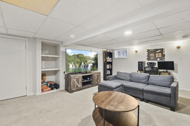 living room with carpet flooring and a drop ceiling