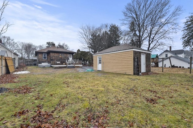 view of yard with a wooden deck and an outbuilding