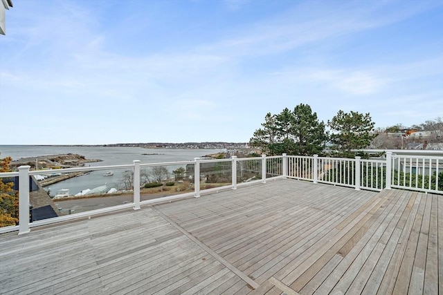 wooden terrace featuring a water view