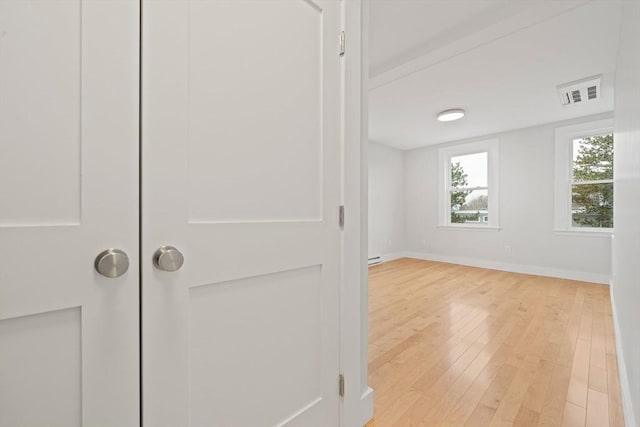 interior space featuring a baseboard radiator and hardwood / wood-style flooring