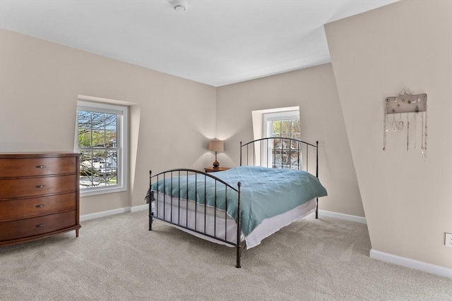 carpeted bedroom with baseboards and multiple windows