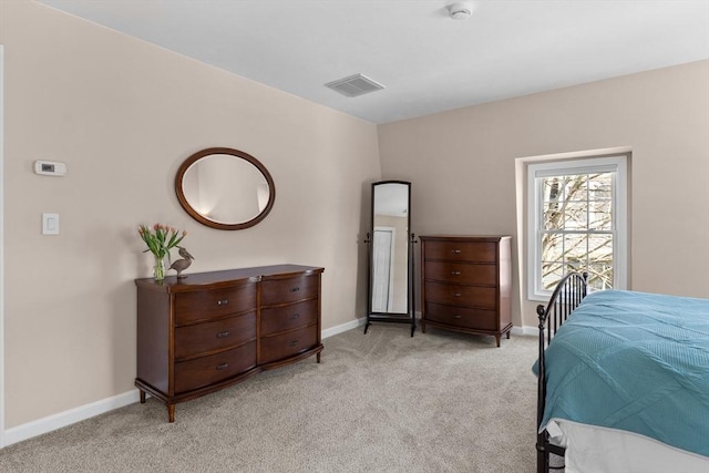 bedroom featuring baseboards, light colored carpet, and visible vents