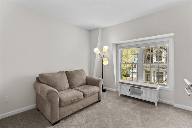 sitting room featuring carpet floors and baseboards