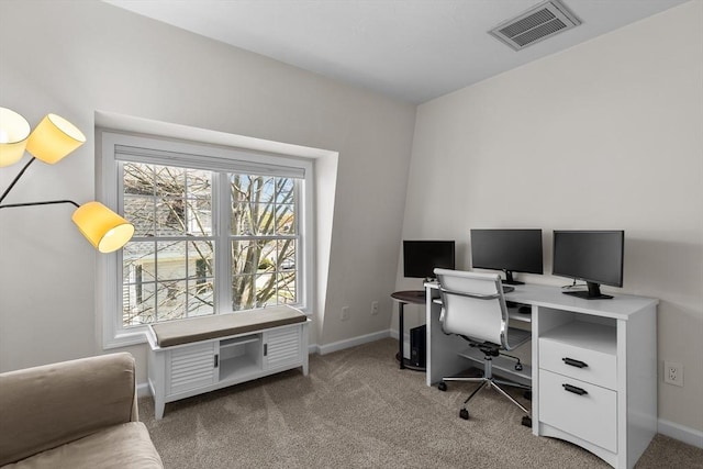 carpeted office space featuring baseboards and visible vents