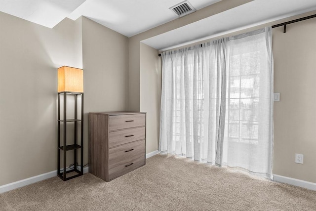 bedroom with carpet floors, baseboards, and visible vents