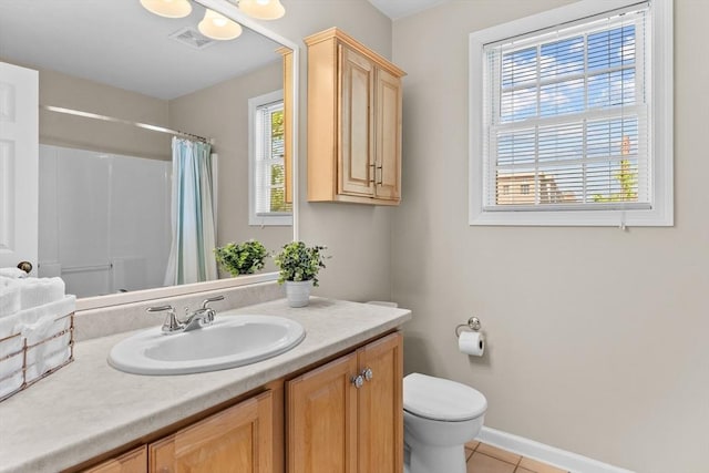 bathroom featuring tile patterned flooring, vanity, toilet, baseboards, and visible vents