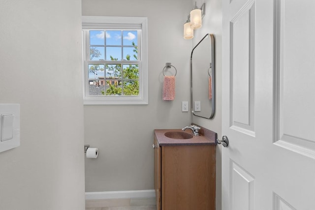bathroom featuring baseboards and vanity