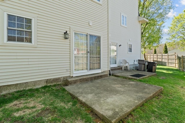 back of house featuring a yard, fence, and a patio area