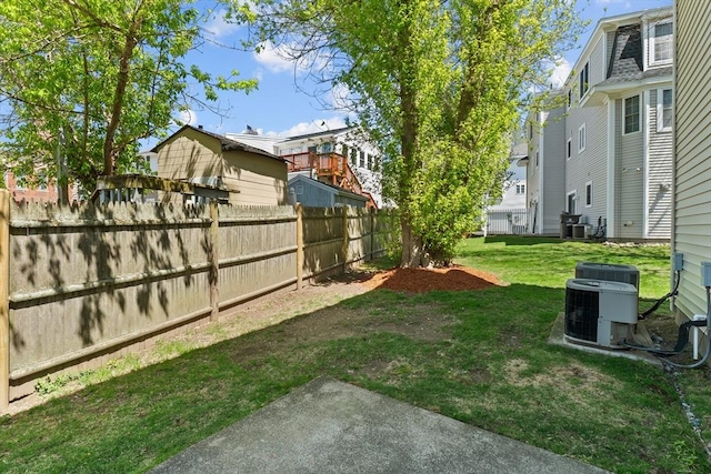view of yard with fence and central AC