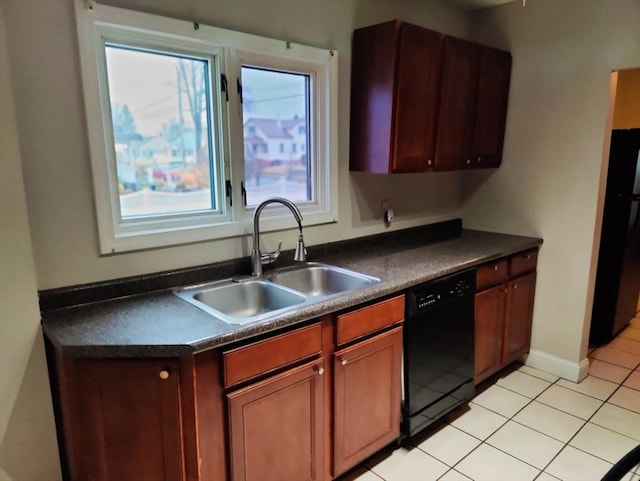 kitchen featuring sink, light tile patterned flooring, and black appliances