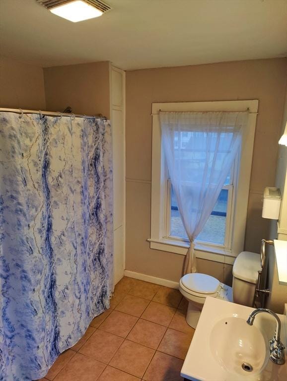 bathroom with tile patterned floors, vanity, toilet, and curtained shower