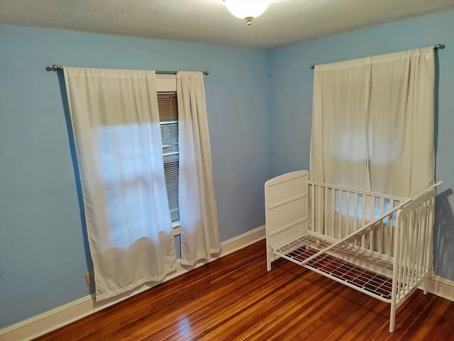 bedroom with wood-type flooring