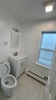 15 York St, Haverhill, MA 01830 - bathroom with baseboard heating, toilet, tile patterned flooring, and vanity