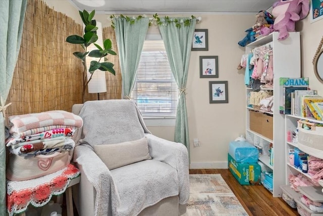 living area with wood finished floors and baseboards