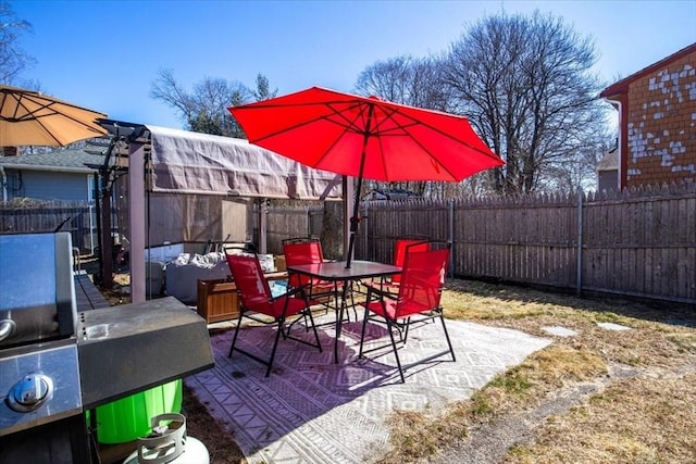 view of patio / terrace with outdoor dining space and a fenced backyard