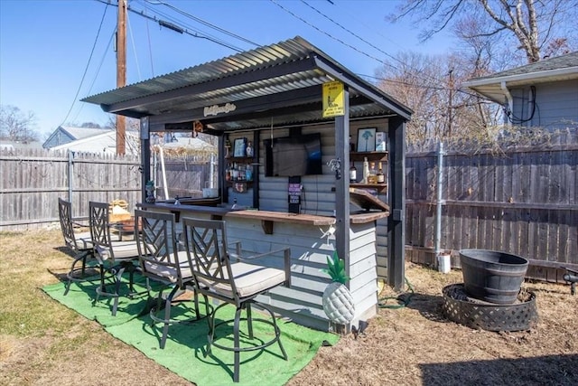 exterior space with fence and outdoor dry bar