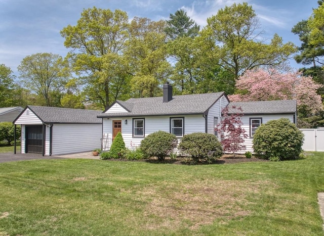 13 Kingston St, North Reading, MA 01864 - view of front of home featuring an outbuilding, a chimney, a detached garage, and a shingled roof